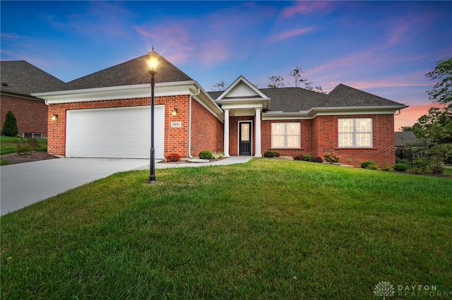 view of front of house featuring a lawn and a garage