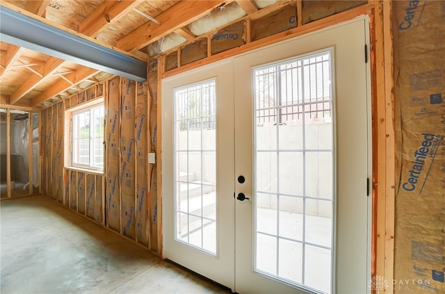 doorway to outside featuring concrete floors and french doors