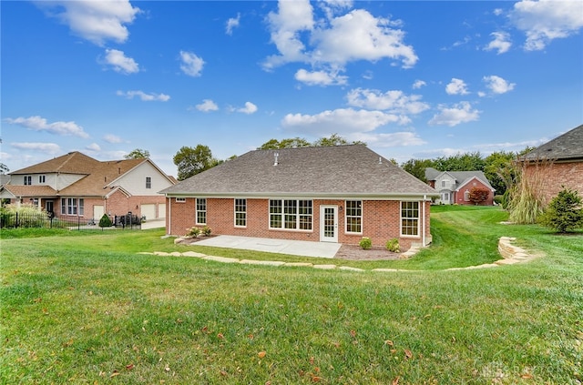 rear view of property with a lawn and a patio area