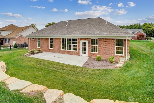 rear view of property with a patio and a yard