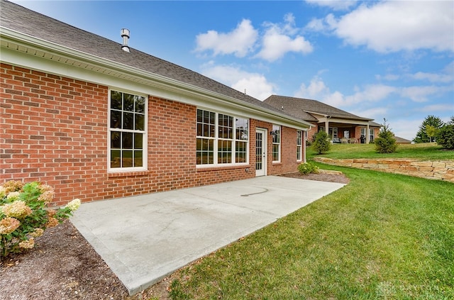 back of house with a lawn and a patio area