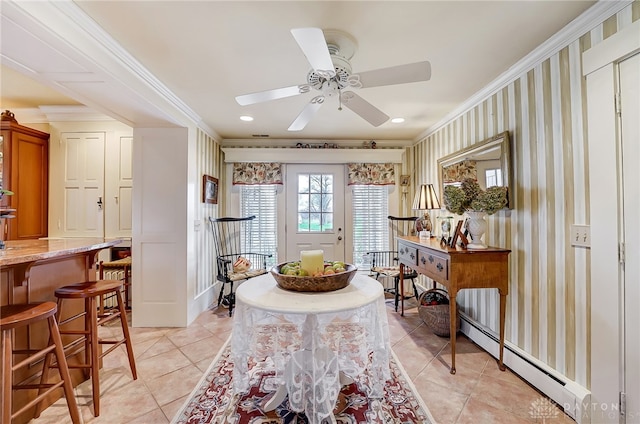 dining area featuring ceiling fan, light tile patterned flooring, baseboard heating, and crown molding