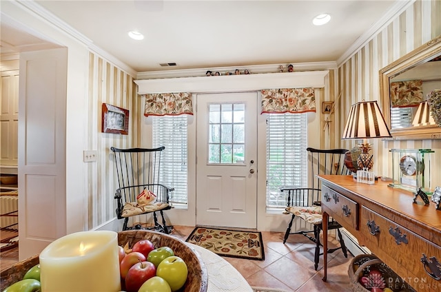 foyer featuring light tile patterned flooring and ornamental molding