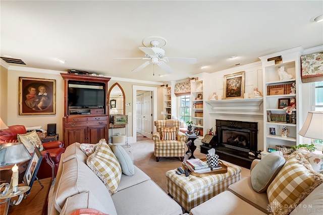 living room featuring ceiling fan and crown molding