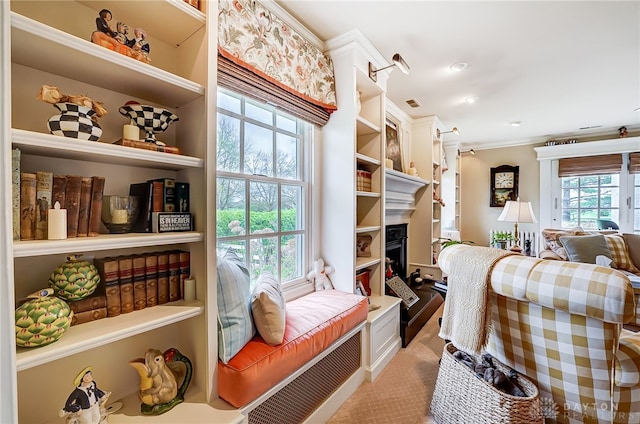 living room with light colored carpet and ornamental molding