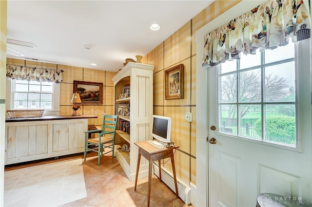 interior space with light tile patterned floors and a baseboard radiator