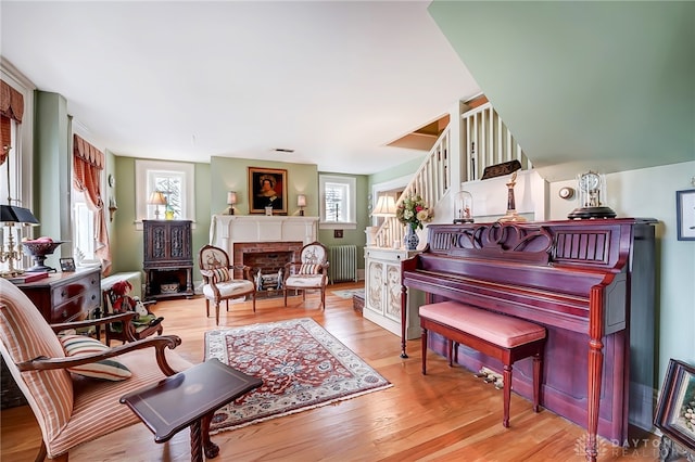 interior space featuring radiator, a fireplace, and light hardwood / wood-style floors