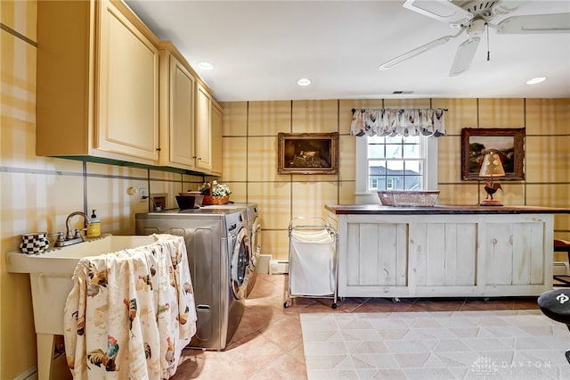 clothes washing area featuring ceiling fan, separate washer and dryer, cabinets, and light tile patterned floors