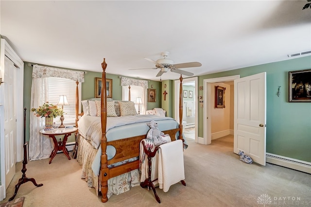 carpeted bedroom with ceiling fan and a baseboard radiator