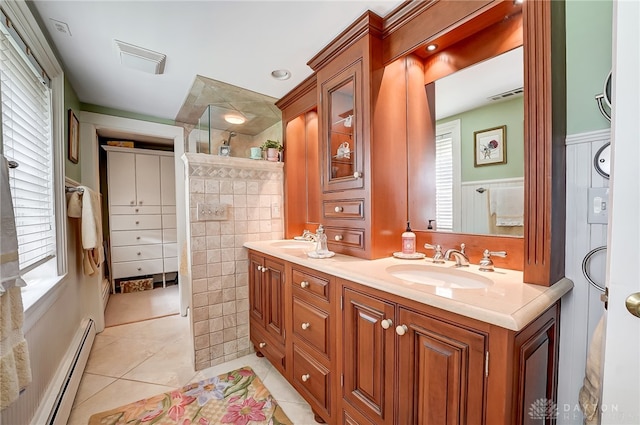 bathroom featuring tile walls, vanity, baseboard heating, and tile patterned floors