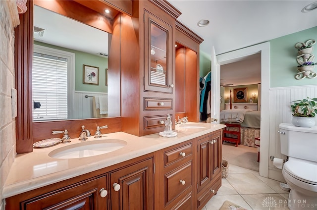 bathroom with vanity, toilet, and tile patterned floors