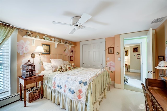 bedroom featuring ceiling fan, light colored carpet, a baseboard radiator, and a closet