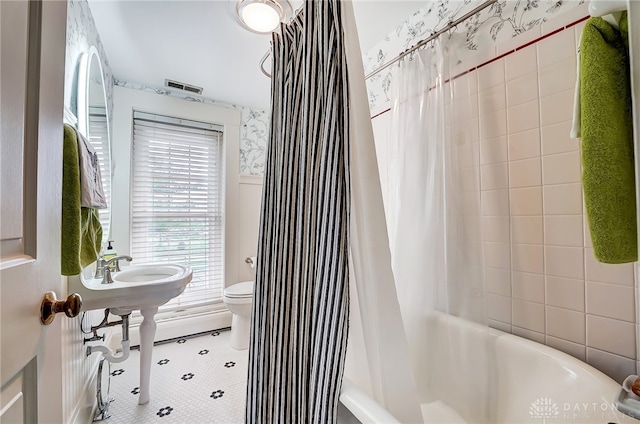 bathroom with shower / tub combo, toilet, and tile patterned floors