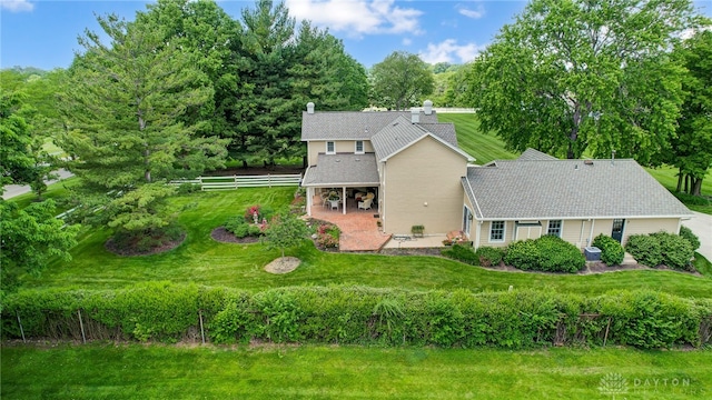 view of front of property with a patio and a front yard