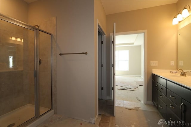 ensuite bathroom with a tile shower, vanity, and ensuite bathroom