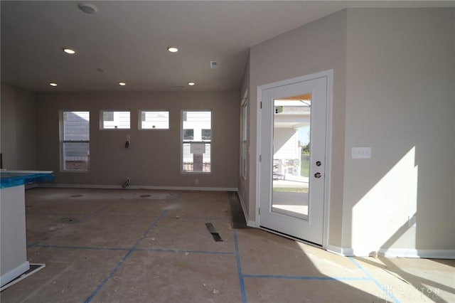 interior space with baseboards and recessed lighting