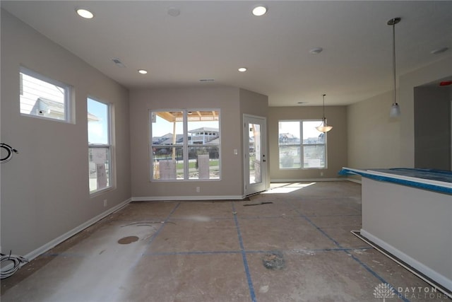 interior space with baseboards and recessed lighting