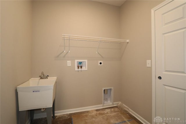 laundry room with baseboards, hookup for an electric dryer, hookup for a washing machine, laundry area, and a sink