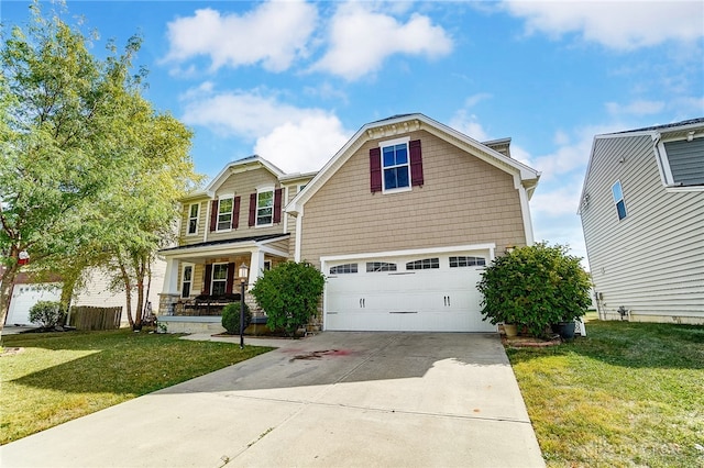 view of property featuring a garage, covered porch, and a front lawn