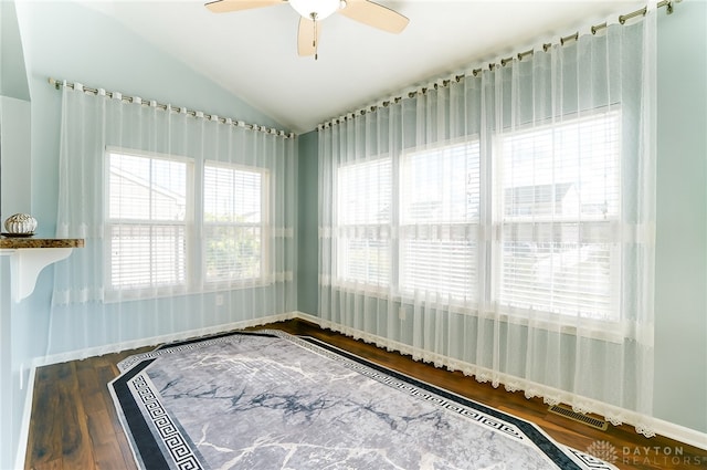 empty room featuring vaulted ceiling, hardwood / wood-style floors, and ceiling fan