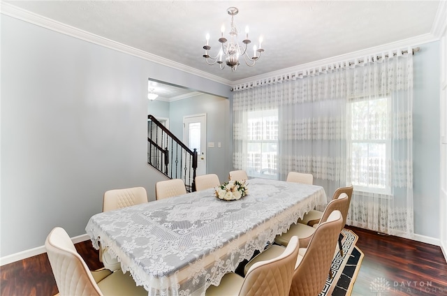 dining room with crown molding, dark wood-type flooring, a chandelier, and a healthy amount of sunlight