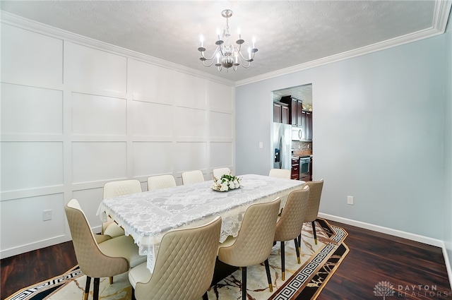 dining area featuring ornamental molding, a textured ceiling, dark hardwood / wood-style floors, and an inviting chandelier