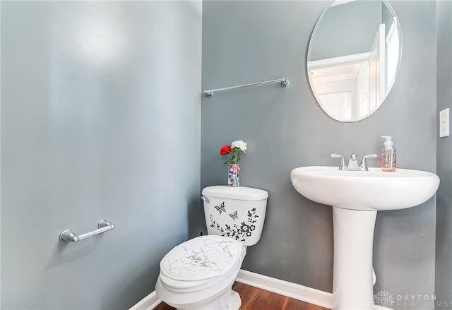 bathroom featuring hardwood / wood-style flooring and toilet