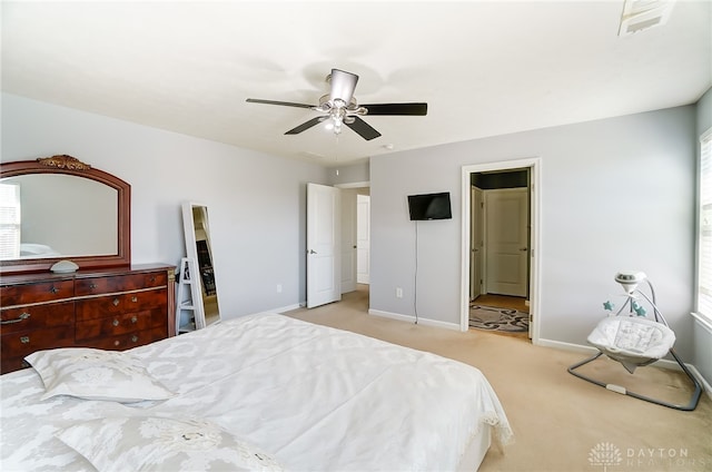 carpeted bedroom featuring ceiling fan and multiple windows