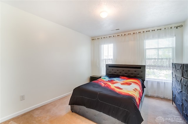 carpeted bedroom featuring a textured ceiling