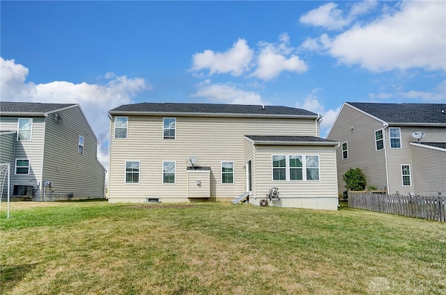 rear view of house featuring a lawn