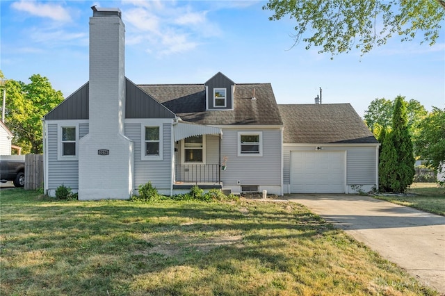 view of front of property with a front yard and a garage