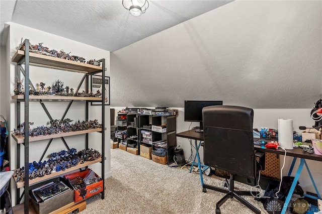 home office featuring carpet floors, a textured ceiling, and vaulted ceiling