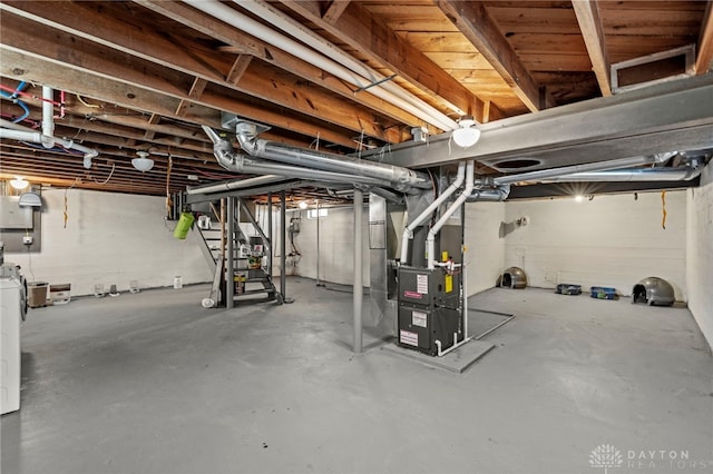 basement with heating unit and washer / clothes dryer