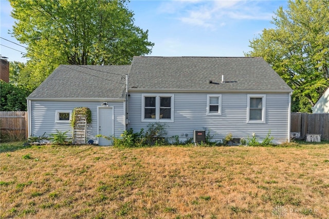 view of front of house featuring a front lawn and central air condition unit