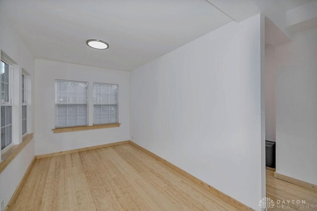 empty room with light hardwood / wood-style flooring