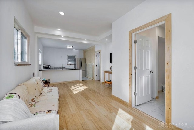 living room with sink and light wood-type flooring