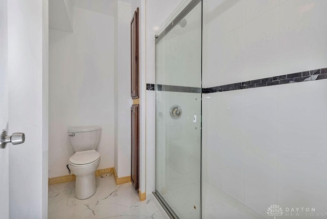 bathroom featuring walk in shower and toilet