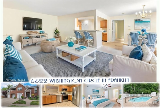 living room featuring ceiling fan with notable chandelier