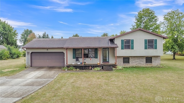 tri-level home with a garage, covered porch, and a front yard