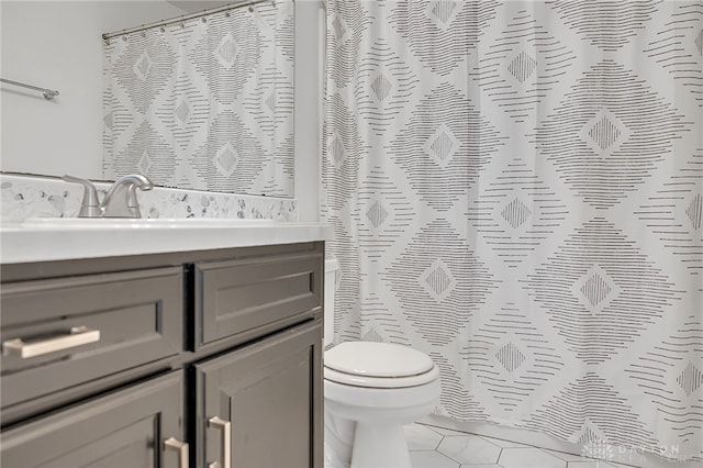 bathroom featuring walk in shower, vanity, tile patterned flooring, and toilet