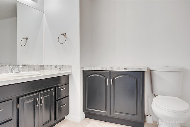 bathroom featuring tile patterned flooring, a textured ceiling, vanity, and toilet