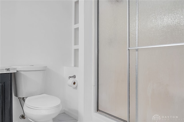 bathroom with an enclosed shower and toilet