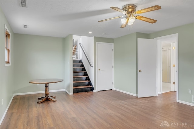 spare room featuring a textured ceiling, light hardwood / wood-style floors, and ceiling fan