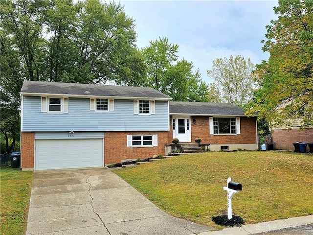 tri-level home featuring a garage and a front yard