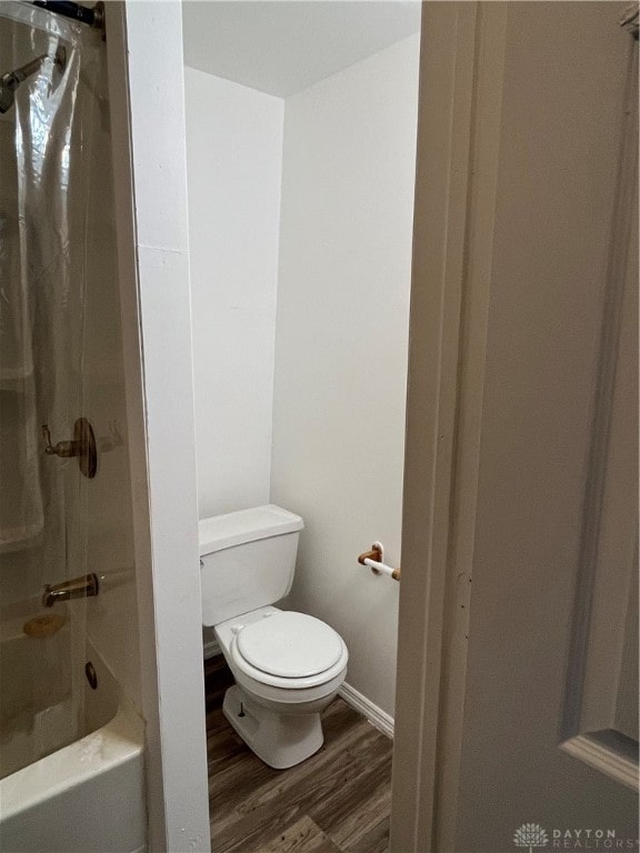 bathroom featuring shower / tub combo with curtain, wood-type flooring, and toilet