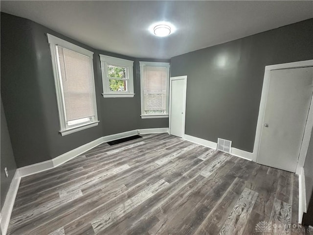 3501 Bevis Ave, Cincinnati, OH 45207 - empty room featuring baseboards, wood finished floors, and visible vents