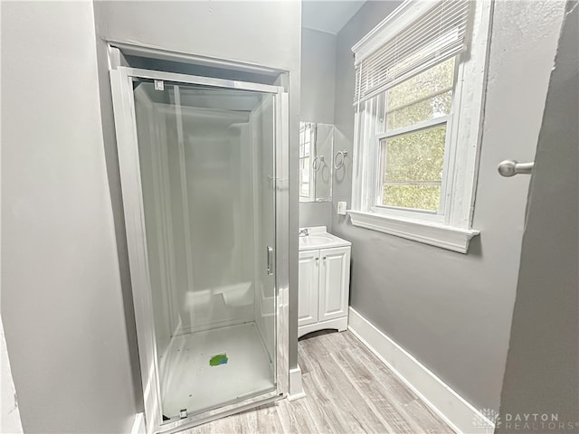 bathroom with an enclosed shower, hardwood / wood-style flooring, and vanity