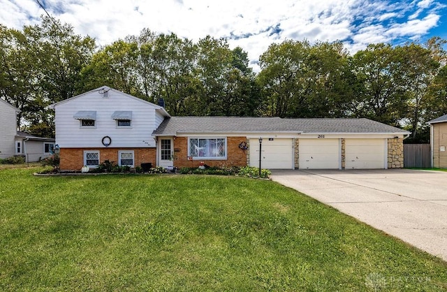 tri-level home with a front yard and a garage