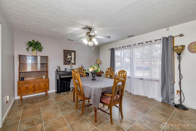 dining room featuring ceiling fan and a textured ceiling