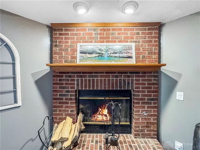 interior details featuring a textured ceiling and a fireplace